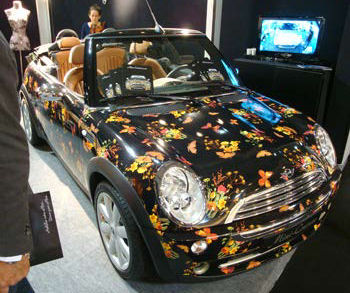 We already commented about the tendency for Mini owners to customize their cars in “X” Marks The Spot! #10. Now here’s a company who offer to dress up your mini … to look just like you?? Mini-Couture offers a whole range of durable “skins” for your mini, guaranteed to last up to three years.